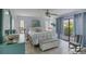 Comfortable bedroom with a large bed, stylish decor, and a sliding door to a patio at 1759 Lake Pl # 1759-B, Venice, FL 34293
