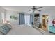 Cozy bedroom features a white bed frame, neutral colored comforter, and adjacent ensuite bathroom at 1759 Lake Pl # 1759-B, Venice, FL 34293
