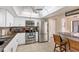 Bright kitchen with white cabinetry, granite countertops, and stainless appliances at 1759 Lake Pl # 1759-B, Venice, FL 34293