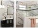 This bathroom features marble walls, sleek fixtures, a sink with vanity, and a glass-enclosed shower with gold hardware at 17817 Woodland Ct, Punta Gorda, FL 33982