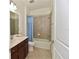 Bathroom featuring a shower and tub combo with vanity and tile flooring at 17817 Woodland Ct, Punta Gorda, FL 33982