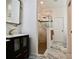 Stylish bathroom with glass enclosed shower, marble countertops and decorative gold fixtures at 17817 Woodland Ct, Punta Gorda, FL 33982