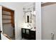 Chic bathroom featuring marble walls, a floating vanity, and an adjacent closet at 17817 Woodland Ct, Punta Gorda, FL 33982