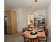 Open-concept dining area features an elegant table and chairs with a designer light fixture at 17817 Woodland Ct, Punta Gorda, FL 33982