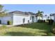 Well-maintained exterior of a home with landscaped lawn and vibrant flower beds at 17817 Woodland Ct, Punta Gorda, FL 33982