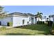 Charming one-story home featuring a manicured lawn, tidy landscaping and light blue exterior paint at 17817 Woodland Ct, Punta Gorda, FL 33982