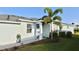 Inviting front entrance with blue exterior, manicured landscaping, and a welcoming walkway at 17817 Woodland Ct, Punta Gorda, FL 33982