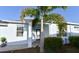 Charming home with a well-maintained lawn, a blue exterior, and a quaint front entrance at 17817 Woodland Ct, Punta Gorda, FL 33982