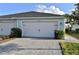 A well-maintained two-car garage with a paved driveway and tidy landscaping, enhancing curb appeal at 17817 Woodland Ct, Punta Gorda, FL 33982