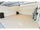 Open two-car garage with epoxy flooring, ample storage and an access door to the home's interior at 17817 Woodland Ct, Punta Gorda, FL 33982