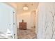 Inviting hallway features neutral décor, wood floors and elegant chandelier at 17817 Woodland Ct, Punta Gorda, FL 33982