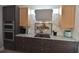 Bright kitchen features gray cabinets, marble counters, stainless double ovens and a colorful decorative fish backsplash at 17817 Woodland Ct, Punta Gorda, FL 33982