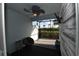 Cozy lanai with fan, wall-mounted TV, and beautiful green views at 17817 Woodland Ct, Punta Gorda, FL 33982