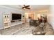 Inviting living room with a ceiling fan, TV, comfortable seating and open floor plan at 17817 Woodland Ct, Punta Gorda, FL 33982