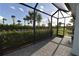 Relaxing screened patio with brick flooring and beautiful views of the manicured greenery at 17817 Woodland Ct, Punta Gorda, FL 33982