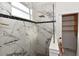 Shower features luxurious marble surround with black accents and a glass partition, adjacent to a closet at 17817 Woodland Ct, Punta Gorda, FL 33982