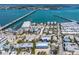 Scenic aerial view of a coastal town featuring charming homes, a harbor, and a bridge in the distance at 205 Highland Ave # 2, Bradenton Beach, FL 34217