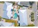 Aerial view of a private property featuring a pool, lush landscaping, and multiple buildings at 205 Highland Ave # 2, Bradenton Beach, FL 34217