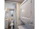 Cozy bathroom featuring a vanity, toilet, and stacked washer/dryer unit at 205 Highland Ave # 2, Bradenton Beach, FL 34217