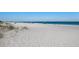 Serene beach view featuring pristine white sand and crystal-clear turquoise waters, ideal for relaxation at 205 Highland Ave # 2, Bradenton Beach, FL 34217