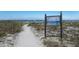 Scenic beach access point with informative signage, leading to a beautiful sandy shoreline at 205 Highland Ave # 2, Bradenton Beach, FL 34217