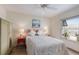 Bright bedroom with hardwood floors, ceiling fan, art and a window overlooking the neighborhood at 205 Highland Ave # 2, Bradenton Beach, FL 34217
