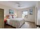 Comfortable bedroom with a ceiling fan, wood floors, and a bright window at 205 Highland Ave # 2, Bradenton Beach, FL 34217