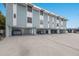 The exterior of this multilevel condo shows covered parking and easy access to residences above at 205 Highland Ave # 2, Bradenton Beach, FL 34217