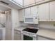 Efficient kitchen with a range, microwave, and plenty of cabinet storage, plus a laundry area nearby at 205 Highland Ave # 2, Bradenton Beach, FL 34217