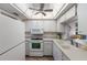 Functional kitchen with white appliances, ample counter space, and a pass-through window to the dining area at 205 Highland Ave # 2, Bradenton Beach, FL 34217