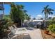 Charming outdoor patio with lounge chairs, grill, and lush landscaping for serene relaxation at 205 Highland Ave # 2, Bradenton Beach, FL 34217