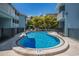 Inviting kidney-shaped pool surrounded by lush tropical greenery in a quaint community setting at 205 Highland Ave # 2, Bradenton Beach, FL 34217