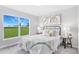 Bright bedroom featuring a large window, soft carpet, and tastefully coordinated decor and furnishings at 23455 Mcnally Ave, Port Charlotte, FL 33980