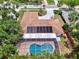 Aerial view of a well-maintained property featuring a screened-in pool and solar panels at 2924 Valley Forge St, Sarasota, FL 34231