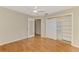 Bedroom featuring hardwood floors, a ceiling fan, sliding closet doors, and an open doorway at 2924 Valley Forge St, Sarasota, FL 34231