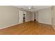 Spacious bedroom with hardwood floors, a ceiling fan, neutral paint, and an open doorway to another room at 2924 Valley Forge St, Sarasota, FL 34231
