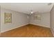 Bedroom with hardwood floors, neutral paint, a ceiling fan, and multiple windows offering natural light at 2924 Valley Forge St, Sarasota, FL 34231
