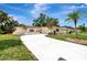 Inviting single-story home featuring a long driveway, shutters, and mature palm trees at 2924 Valley Forge St, Sarasota, FL 34231