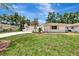 Charming single-story home with well-manicured lawn and lush landscaping on a sunny day at 2924 Valley Forge St, Sarasota, FL 34231