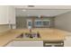 Close up of stainless steel sink area with pool view in bright kitchen at 2924 Valley Forge St, Sarasota, FL 34231