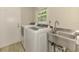 Bright laundry room with newer washer and dryer units and utility sink at 2924 Valley Forge St, Sarasota, FL 34231