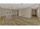Open-concept living room with wood-look tile flooring and French doors leading to the pool at 2924 Valley Forge St, Sarasota, FL 34231