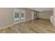 Bright living room featuring wood-look tile floors, neutral paint, and French doors to the pool at 2924 Valley Forge St, Sarasota, FL 34231