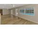 Bright living room featuring hardwood floors, neutral paint, a ceiling fan, and views of the outdoor pool at 2924 Valley Forge St, Sarasota, FL 34231
