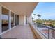 Large balcony with sliding glass doors and views of palms at 3030 Grand Bay Blvd # 323, Longboat Key, FL 34228