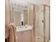 Well-lit bathroom featuring a glass door walk-in shower, and a sink at 3030 Grand Bay Blvd # 323, Longboat Key, FL 34228
