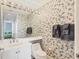 Well-lit bathroom with a sink and toilet in a condo at 3030 Grand Bay Blvd # 323, Longboat Key, FL 34228