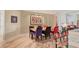 Dining room with wood floors, decorative artwork, and colorful accents at 3030 Grand Bay Blvd # 323, Longboat Key, FL 34228