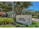 Beautiful sign for Grand Bay with mature landscaping and trees at 3030 Grand Bay Blvd # 323, Longboat Key, FL 34228