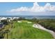 Scenic view of a lush golf course with manicured greens and sand traps, by the water with single player present at 3030 Grand Bay Blvd # 323, Longboat Key, FL 34228